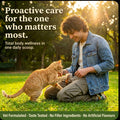 Man outdoors on grass with an orange cat, promoting vet-formulated, taste-tested daily wellness care
